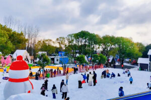 Outdoor snow park with visitors enjoying artificial snow attractions
