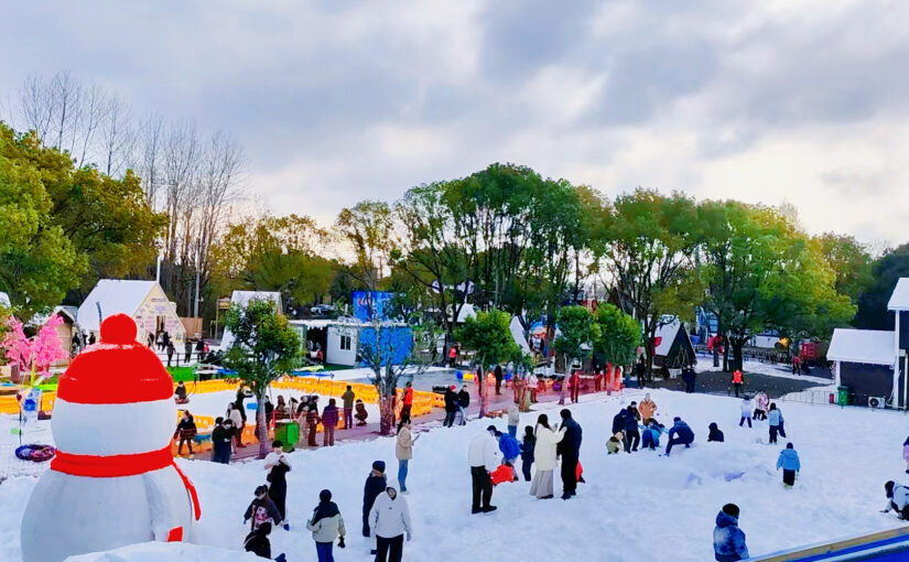 Outdoor snow park with visitors enjoying artificial snow attractions